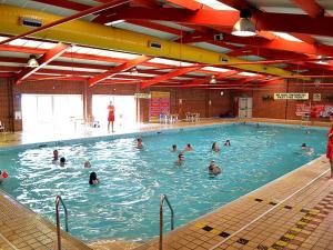 a group of people swimming in a swimming pool at Gold Plus Caravan in Dymchurch