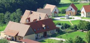 an overhead view of a large house with brown roofs at Ferienanlage Karolinenhof 2 in Haundorf