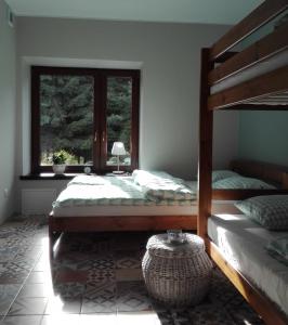 a bedroom with two beds and a window at Apartament Leszczynowa 7 blisko Zatora in Spytkowice