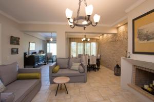 a living room with a couch and a fireplace at Golden Coast Boutique - Luxury Living in Kypseli