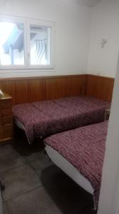 two beds in a room with a window at les tilleuls in Léon