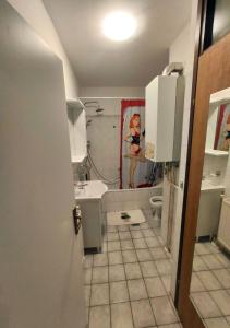 a bathroom with a sink and a toilet and a shower at Apartment in quiet area with free parking in Varaždin