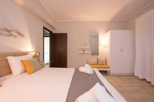 a bedroom with a large white bed and a chair at Golden Coast Boutique - Luxury Living in Kypseli +111 photos