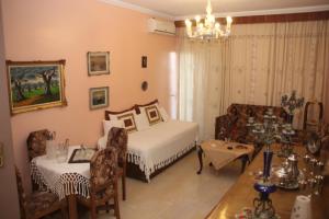 a bedroom with a bed and a table and chairs at 3 Brothers II - Vintage - Μια άλλη εποχή in Tríkala