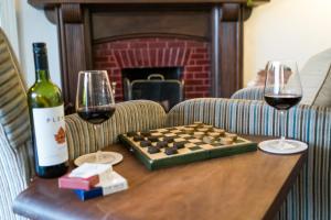 a chess board and two glasses of wine on a table at Lancrigg in Grasmere