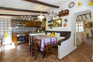 a kitchen with a table with a table cloth on it at Villa La Liccia Misia in Santa Teresa Gallura