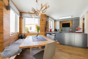 a kitchen with a wooden table with a vase on it at Chalet Gretl in Oberstdorf