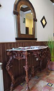 a wooden table sitting in front of a mirror at Hotel Sierra de Araceli Lucena in Lucena