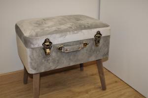 an old suitcase is sitting on a stool at CASA AMABLE in La Roza