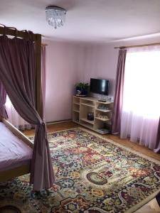 a bedroom with a bed and a rug and a window at Casa Weiss in Sibiu