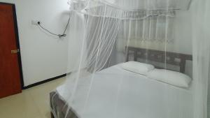 Una cama o camas en una habitación de Bandulas Beach House