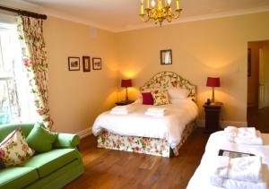 a hotel room with a bed and a couch at Delphi Lodge in Leenaun