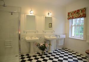 a bathroom with two sinks and two mirrors at Delphi Lodge in Leenaun