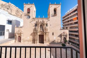 an old church with a clock tower on a building at Apartamento Santa Maria by Be Alicante in Alicante