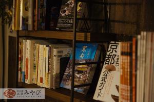 a book shelf filled with lots of books at Gojo Miyabi Inn in Kyoto