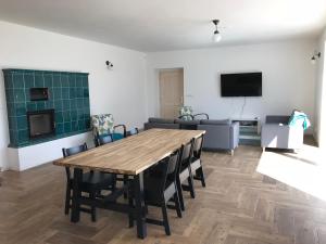 a living room with a wooden table and a couch at Chalupa U Kačírků in Horní Planá