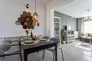a dining room and living room with a table and chairs at Pansion Tina in Šilo