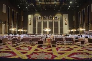 a large banquet hall with tables and chairs in it at Hukam's Lalit Mahal in Raipur