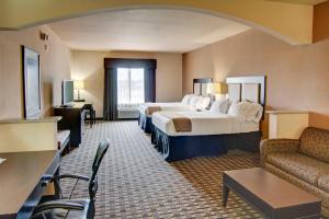 a hotel room with two beds and a couch at Holiday Inn Express Hotel & Suites Paris by IHG in Paris +38 photos