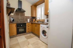 a kitchen with a washing machine and a washer at La Maison de la Plage, by Comfortable Luxury in Corralejo +14 photos