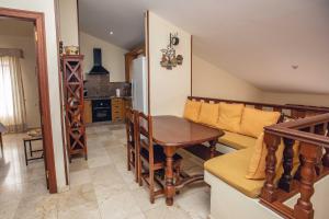 a living room with a table and a couch at La Maison de la Plage, by Comfortable Luxury in Corralejo