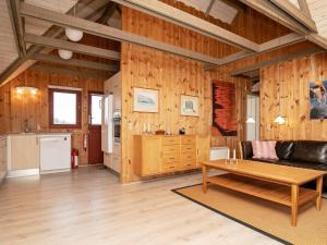 a living room with a couch and a table at 6 person holiday home in Hvide Sande in Bjerregård