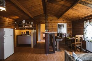 a kitchen with a refrigerator and a table in a room at Fuente del Lobo Glamping & Bungalows - Adults Only in Pinos Genil