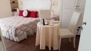 a bedroom with a bed with a table and a chair at Sweet Dreams in La Spezia