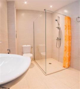 a bathroom with a shower and a sink and a toilet at Moreto Seaside Aparthotel in Obzor
