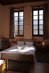a bedroom with a bed with two animals on it at Peklaritiko Steki in Pigí +23 photos