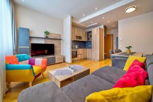 a living room with a couch and a table at Luxury Kalman Centar Apartman in Zlatibor