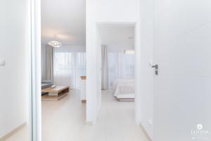 Posteľ alebo postele v izbe v ubytovaní Jantar Apartamenty Bliżej Morza
