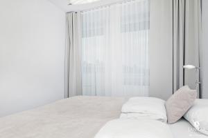 Posteľ alebo postele v izbe v ubytovaní Jantar Apartamenty Bliżej Morza