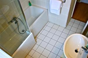 a bathroom with a shower and a toilet and a sink at L'Hôtel du Périgord in Aubeterre-sur-Dronne +17 photos