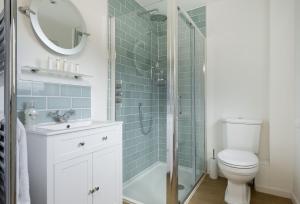 a bathroom with a shower and a toilet and a sink at Fairfields in Moreton in Marsh