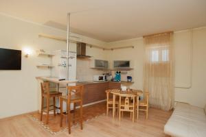 a kitchen and dining room with a table and chairs at Style Hotel in Lipetsk