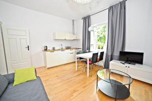 a living room with a couch and a table at White Sand Apartment Centrum by Grand Apartments in Sopot