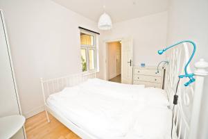 a hospital bed in a white room with a window at White Sand Apartment Centrum by Grand Apartments in Sopot
