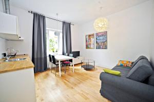 a living room with a couch and a table at White Sand Apartment Centrum by Grand Apartments in Sopot