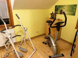 a gym with two exercise bikes in a room at Ferienhaus im Kumbachtal in Gräfenthal