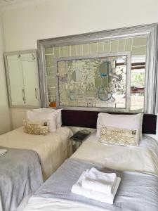2 camas con toallas en una habitación en Old Post Office Lodge en Wilderness