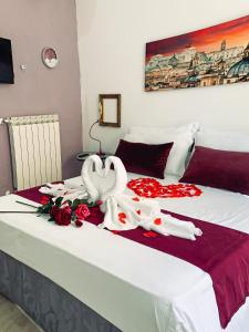 una cama con un cisne hecho de rosas en ArtHouse Termini, en Roma