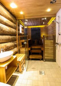 a bathroom with a toilet and a sink and a shower at Villa Vuossel in Ruka