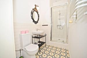 a bathroom with a toilet and a sink and a shower at White Marina Apartment by Grand Apartments in Sopot