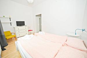 a bedroom with a bed and a desk and a tv at White Marina Apartment by Grand Apartments in Sopot