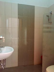 a bathroom with a sink and a shower at Mandalawangi Hotel in Tasikmalaya