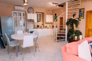 a kitchen and living room with a table and chairs at Casa Pasinovic in Kotor