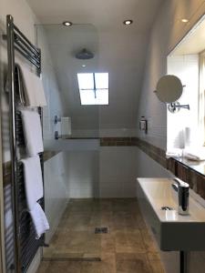 a bathroom with a bath tub and a sink at The Admiral Hornblower in Oakham