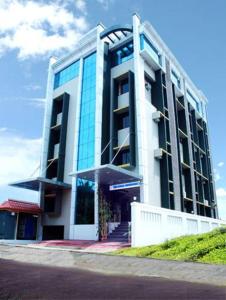 a large building with glass windows on the side of it at TRI-STAR RESIDENCY Cochin in Ernakulam