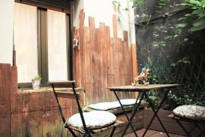 a patio with two chairs and a table and a fence at Apartamento Jare in Bilbao